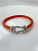 Fiasrel A horseshoe-studded studded woven bracelet